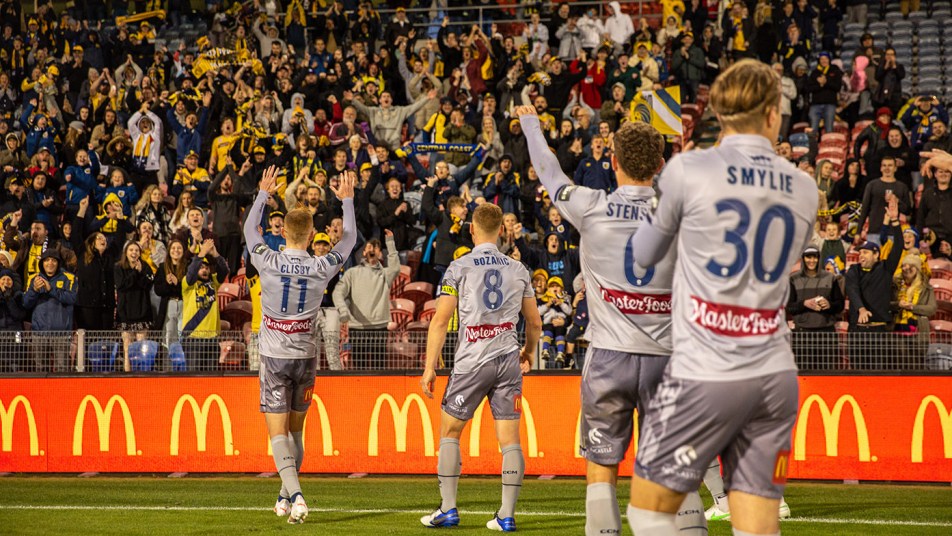 Mariners players celebrate with fans in Newcastle