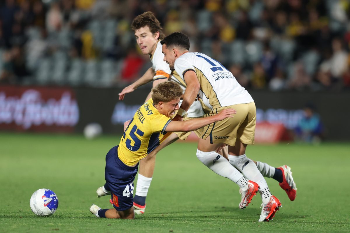 Jesse Mantell of the Mariners is tackled by Zach Clough of the Jets at Polytec Stadium.